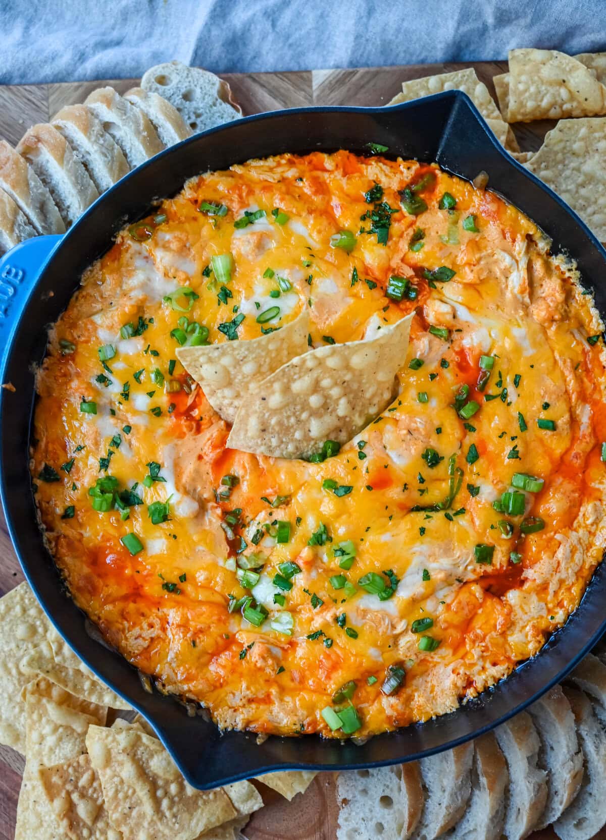 This Hot Creamy Buffalo Chip Dip is made with tender shredded chicken, cream cheese, buffalo sauce, ranch dressing, and topped with cheese, and baked until warm and bubbly. This is a perfect Super Bowl appetizer and this Chicken Hot Wing Dip is always a hit!