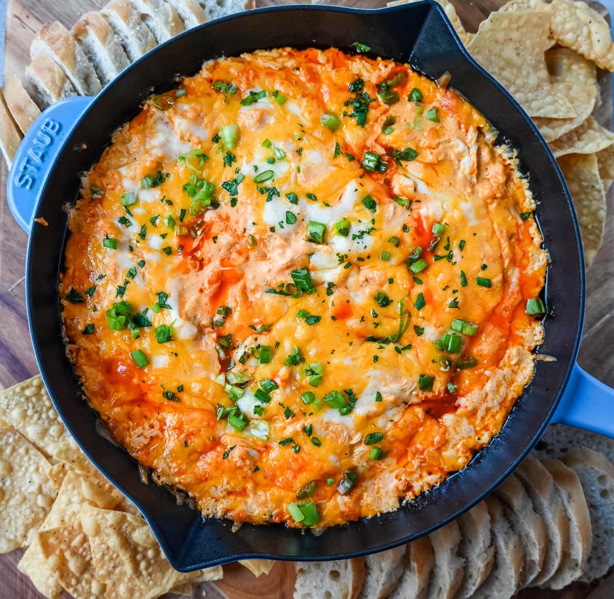 This Hot Creamy Buffalo Chip Dip is made with tender shredded chicken, cream cheese, buffalo sauce, ranch dressing, and topped with cheese, and baked until warm and bubbly. This is a perfect Super Bowl appetizer and this Chicken Hot Wing Dip is always a hit!