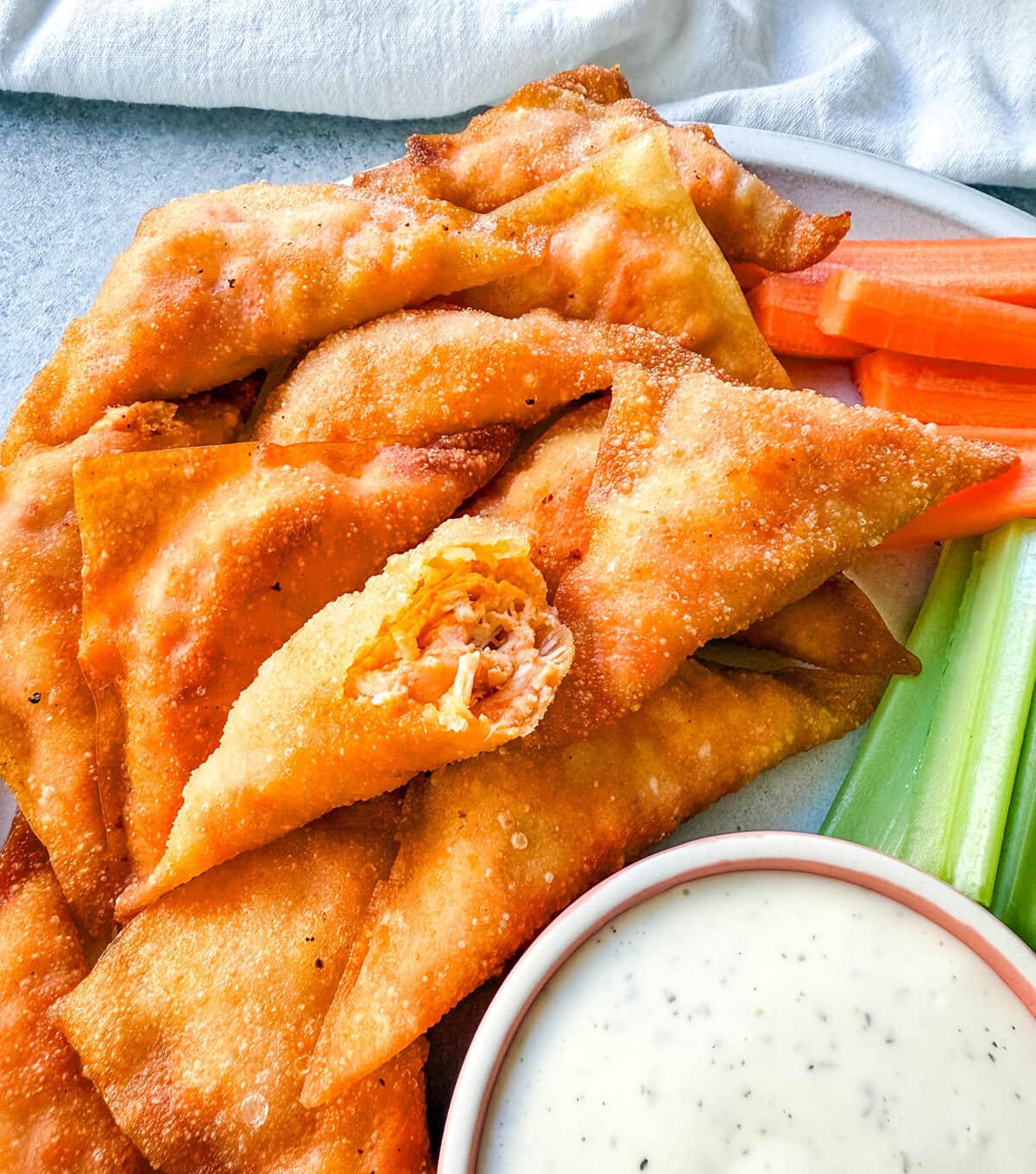 Buffalo Blasts are a crispy, spicy, and flavorful appetizer that combines tangy buffalo chicken and cheese in golden fried pockets. These bite-size appetizers made with a blend of melted cheese, tender chicken, and zesty buffalo sauce, are wrapped in wonton wrappers and fried to golden perfection. These popular Cheesecake Factory Buffalo Blasts are a super popular appetizer.