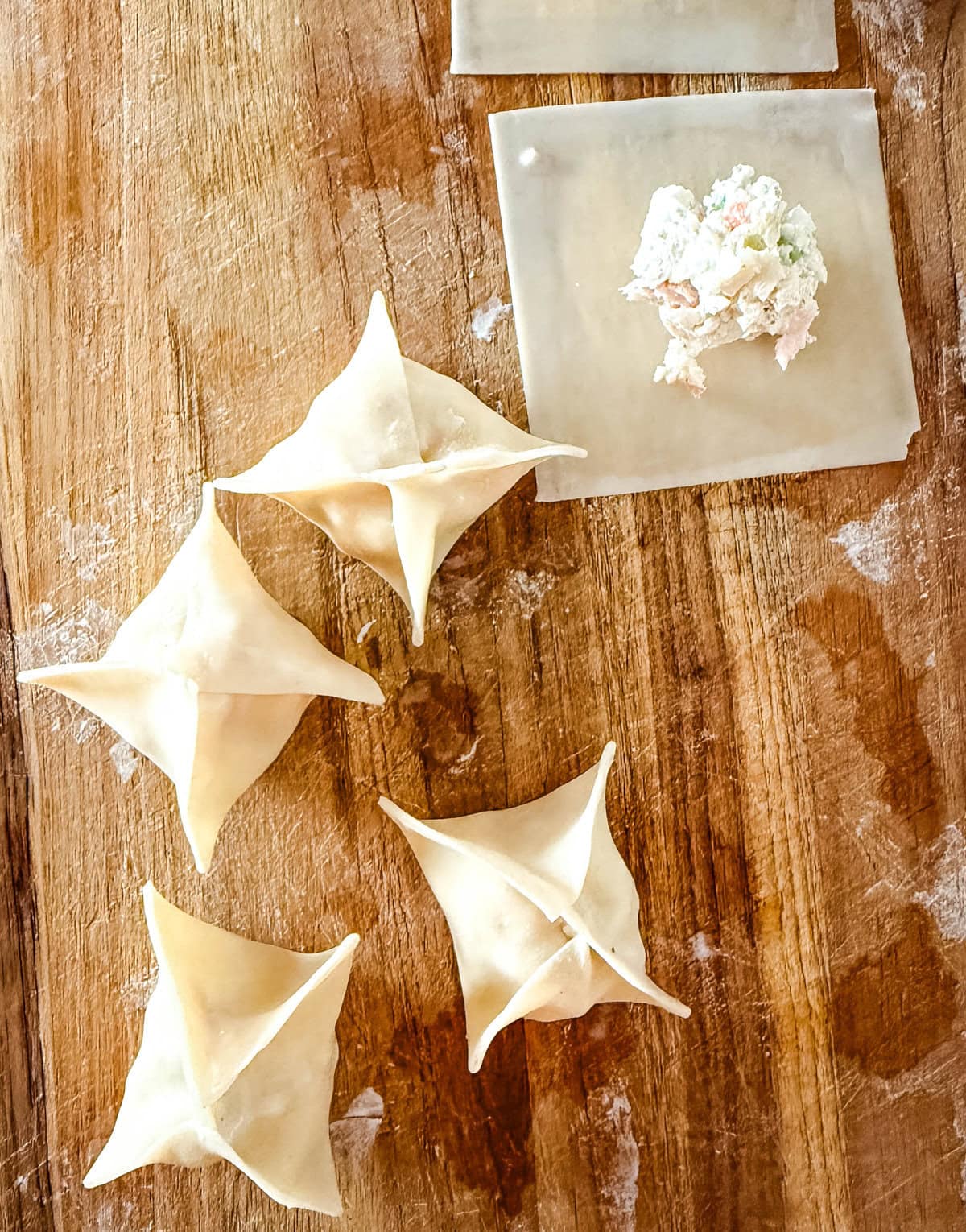 Making crab rangoons and how to seal the wontons.