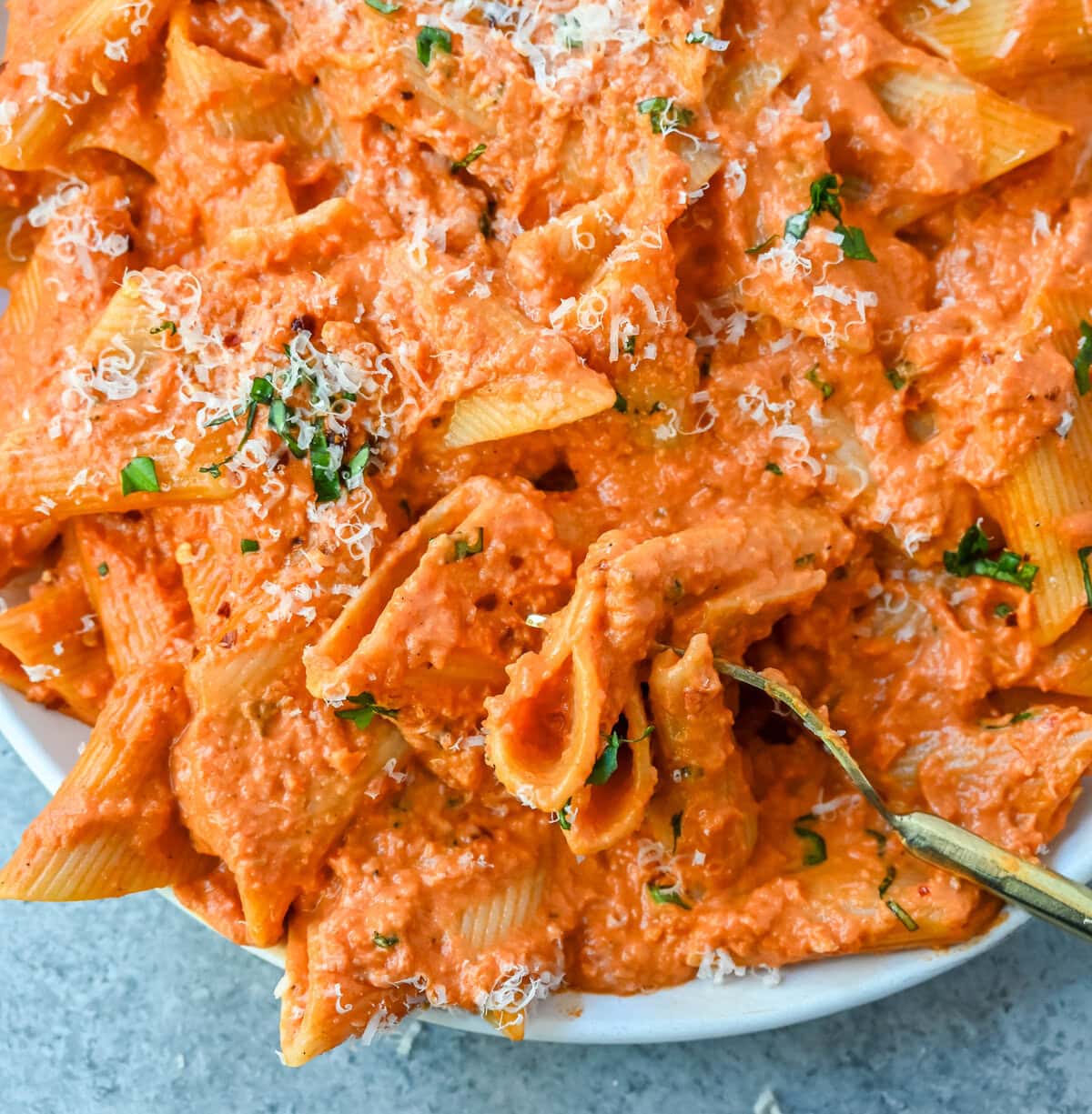 Penne alla Vodka is a classic Italian-American dish featuring a rich, creamy tomato sauce with a touch of vodka. While the alcohol cooks off, the vodka adds a subtle depth and brightness that sets this recipe apart from a standard marinara or tomato cream sauce. You will love this Love at First Bite Pasta!