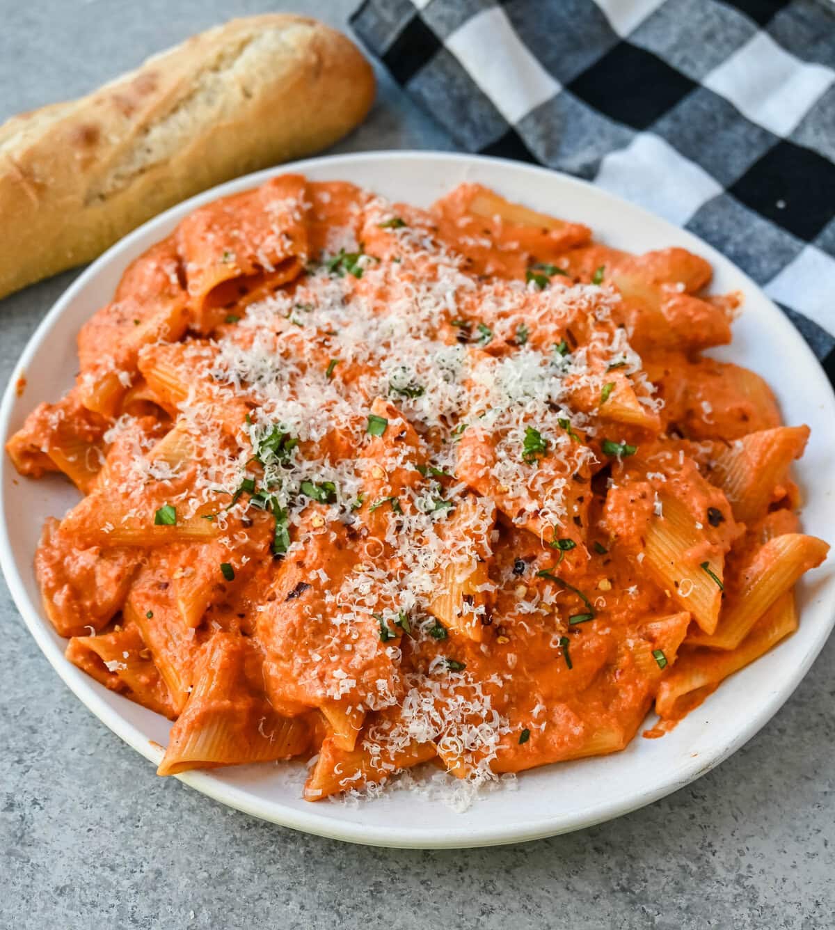 Penne alla Vodka is a classic Italian-American dish featuring a rich, creamy tomato sauce with a touch of vodka. While the alcohol cooks off, the vodka adds a subtle depth and brightness that sets this recipe apart from a standard marinara or tomato cream sauce. You will love this Love at First Bite Pasta!