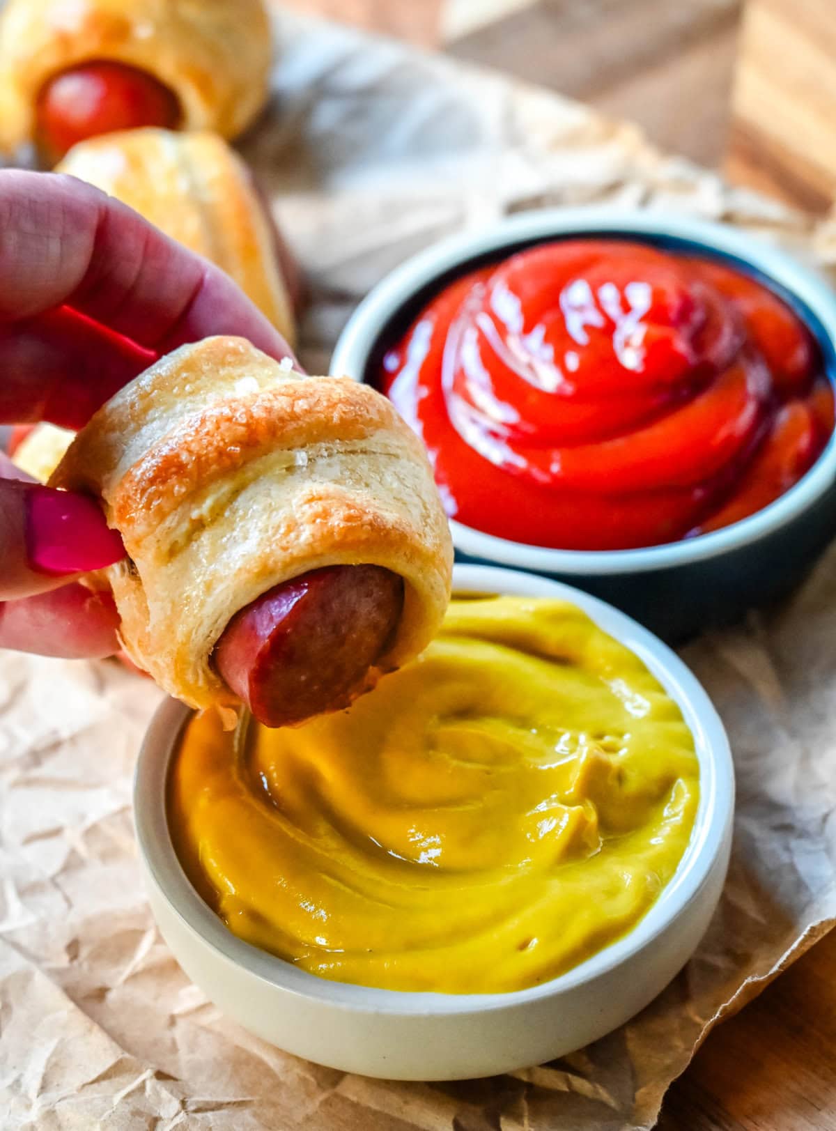 These Pigs in a Blanket are a classic, crowd-pleasing appetizer with juicy hot dogs wrapped in flaky crescent dough and baked until golden. These crescent roll hot dogs are so easy to prepare and you can even customize them into pretzel dogs. This is such an easy party appetizer to whip up in less than 30 minutes.