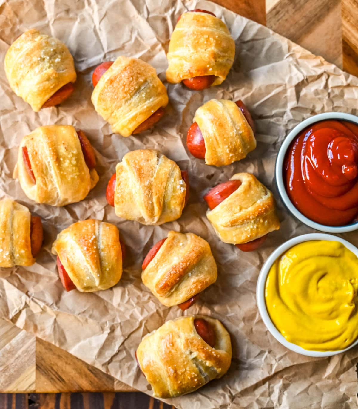 These Pigs in a Blanket are a classic, crowd-pleasing appetizer with juicy hot dogs wrapped in flaky crescent dough and baked until golden. These crescent roll hot dogs are so easy to prepare and you can even customize them into pretzel dogs. This is such an easy party appetizer to whip up in less than 30 minutes.