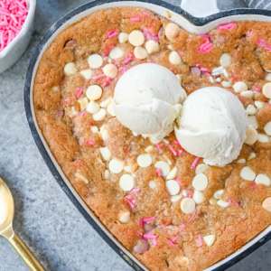 Valentine's Day Heart Skillet Cookie. Soft, chewy skillet cookie recipe filled with white chocolate chips, pink sprinkles, and any of your favorite festive additions such as Valentine's Day M&M's and ruby chocolate. Top it with vanilla ice cream and have the perfect Valentine's Day dessert.