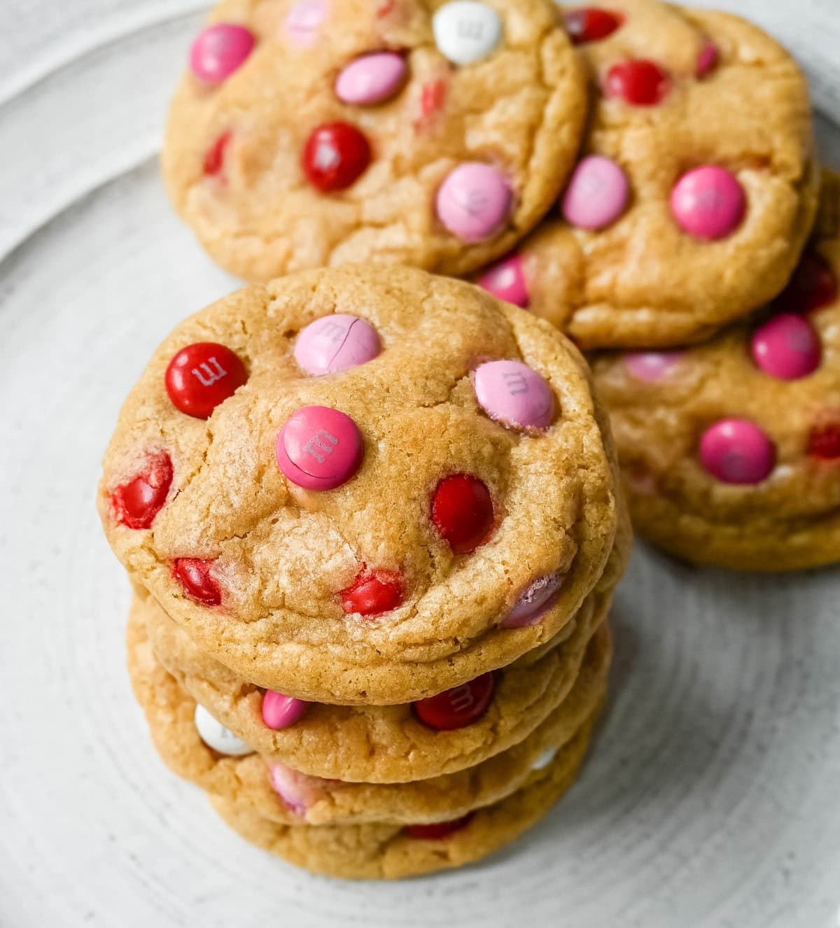 How to make the perfect Valentine's Day cookies. These soft and chewy Valentine's M&M Cookies have pops of pink, red, and white M&M's to make them not only delicious but festive and fun as well. You will love these Valentine's cookies!