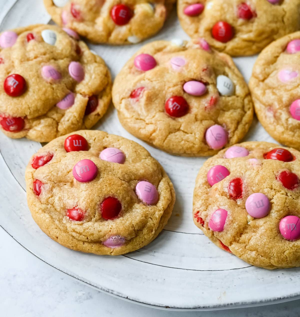 How to make the perfect Valentine's Day cookies. These soft and chewy Valentine's M&M Cookies have pops of pink, red, and white M&M's to make them not only delicious but festive and fun as well. You will love these Valentine's cookies!