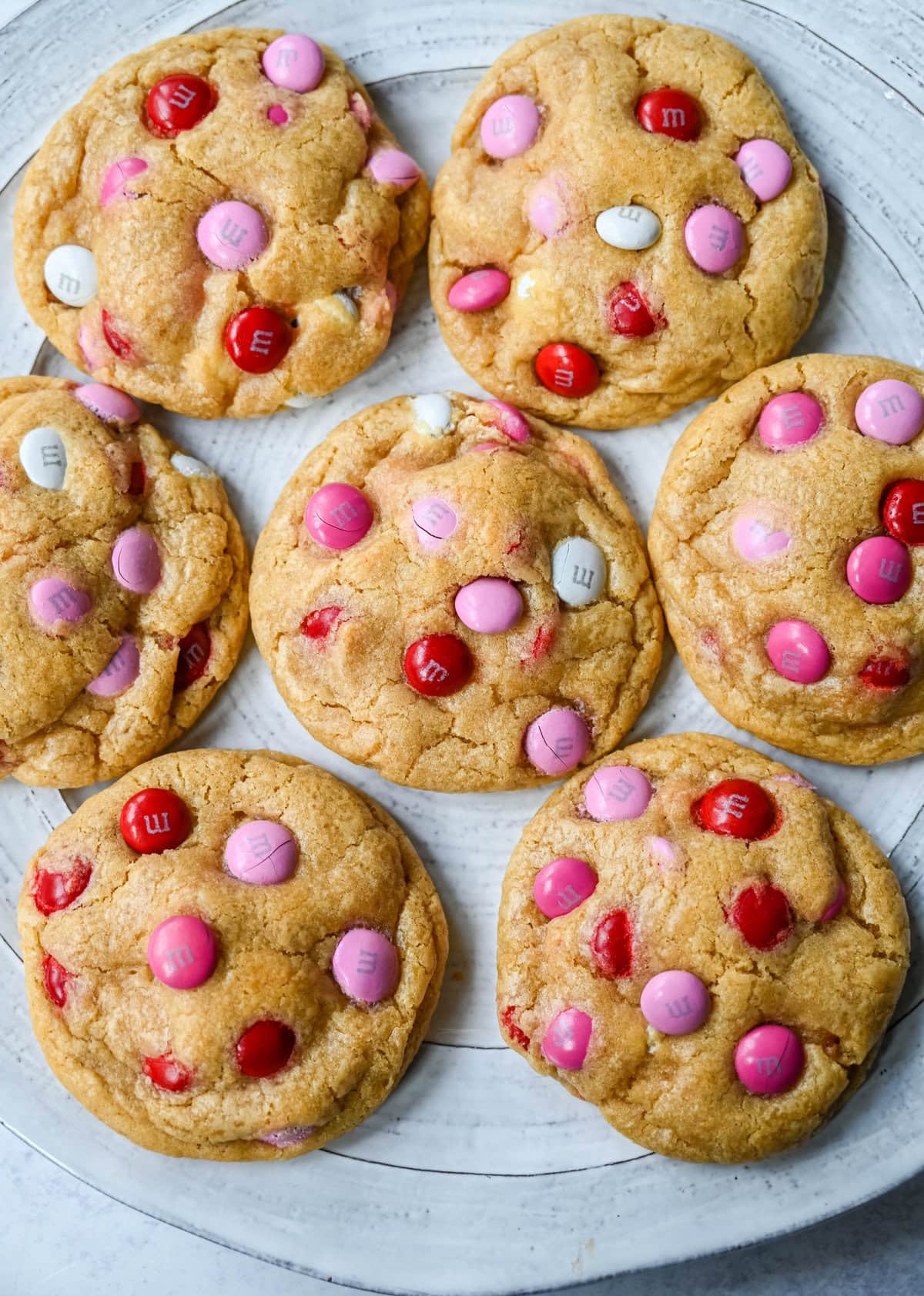 How to make the perfect Valentine's Day cookies. These soft and chewy Valentine's M&M Cookies have pops of pink, red, and white M&M's to make them not only delicious but festive and fun as well. You will love these Valentine's cookies!