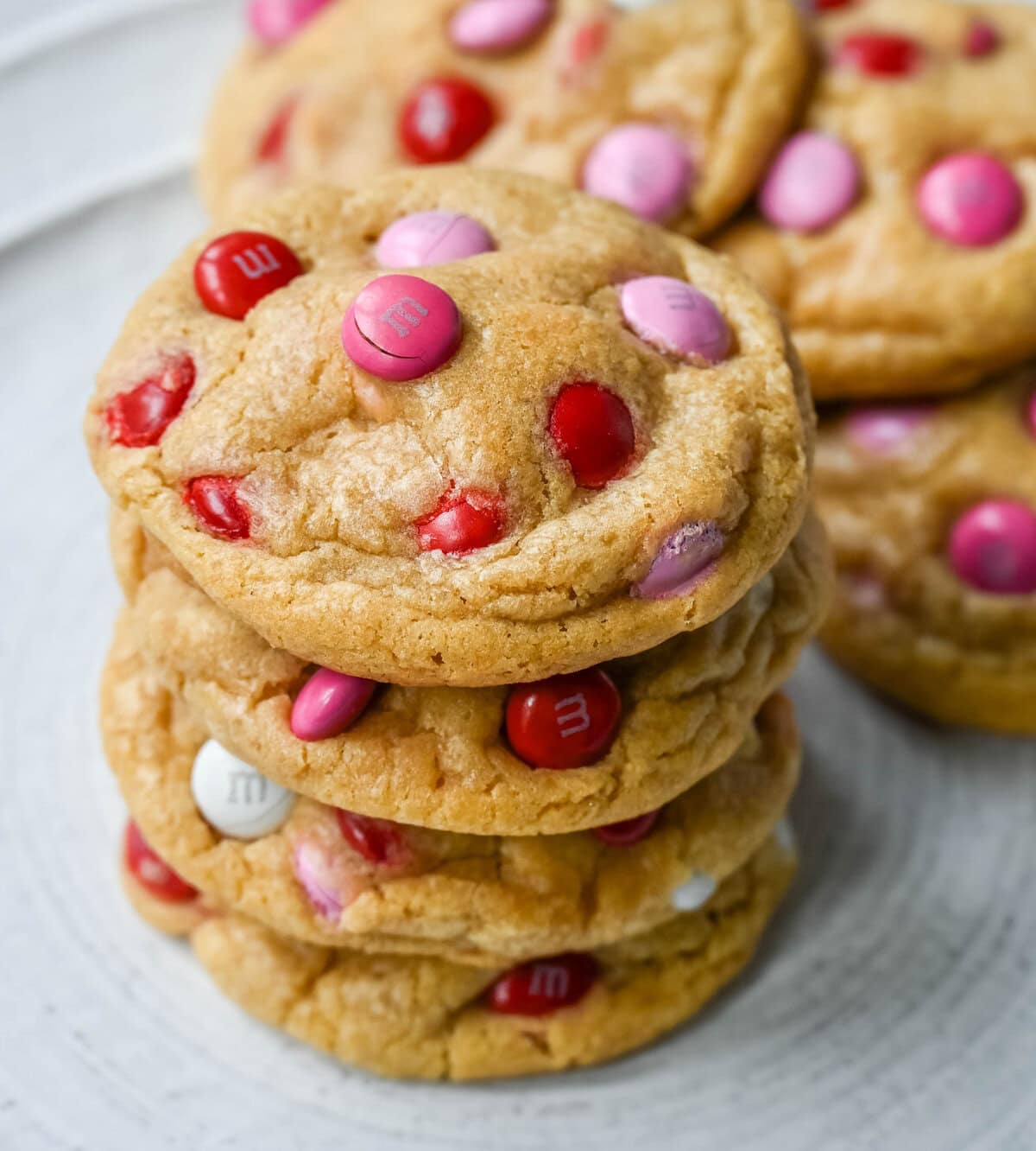 How to make the perfect Valentine's Day cookies. These soft and chewy Valentine's M&M Cookies have pops of pink, red, and white M&M's to make them not only delicious but festive and fun as well. You will love these Valentine's cookies!