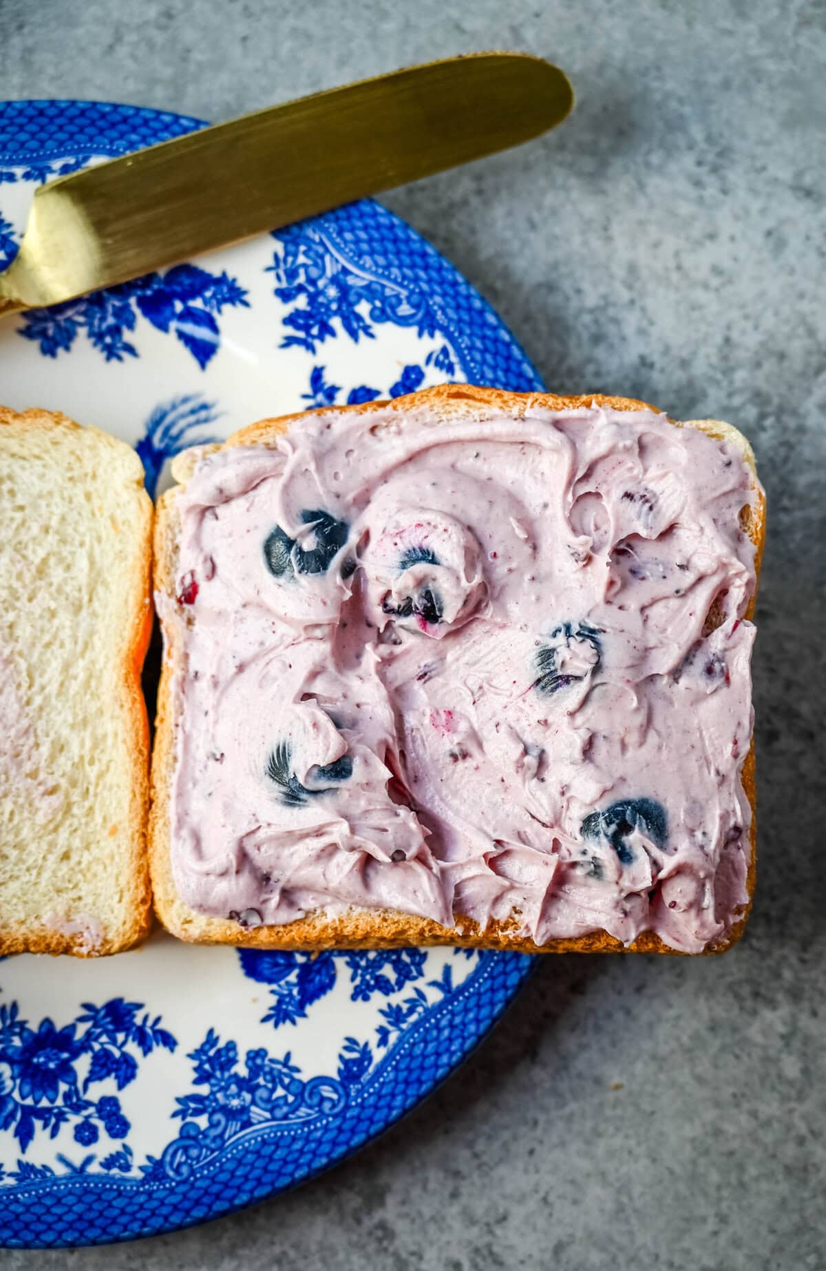 Spread the blueberry Cream Cheese on bread for blueberry cream cheese stuffed french toast.