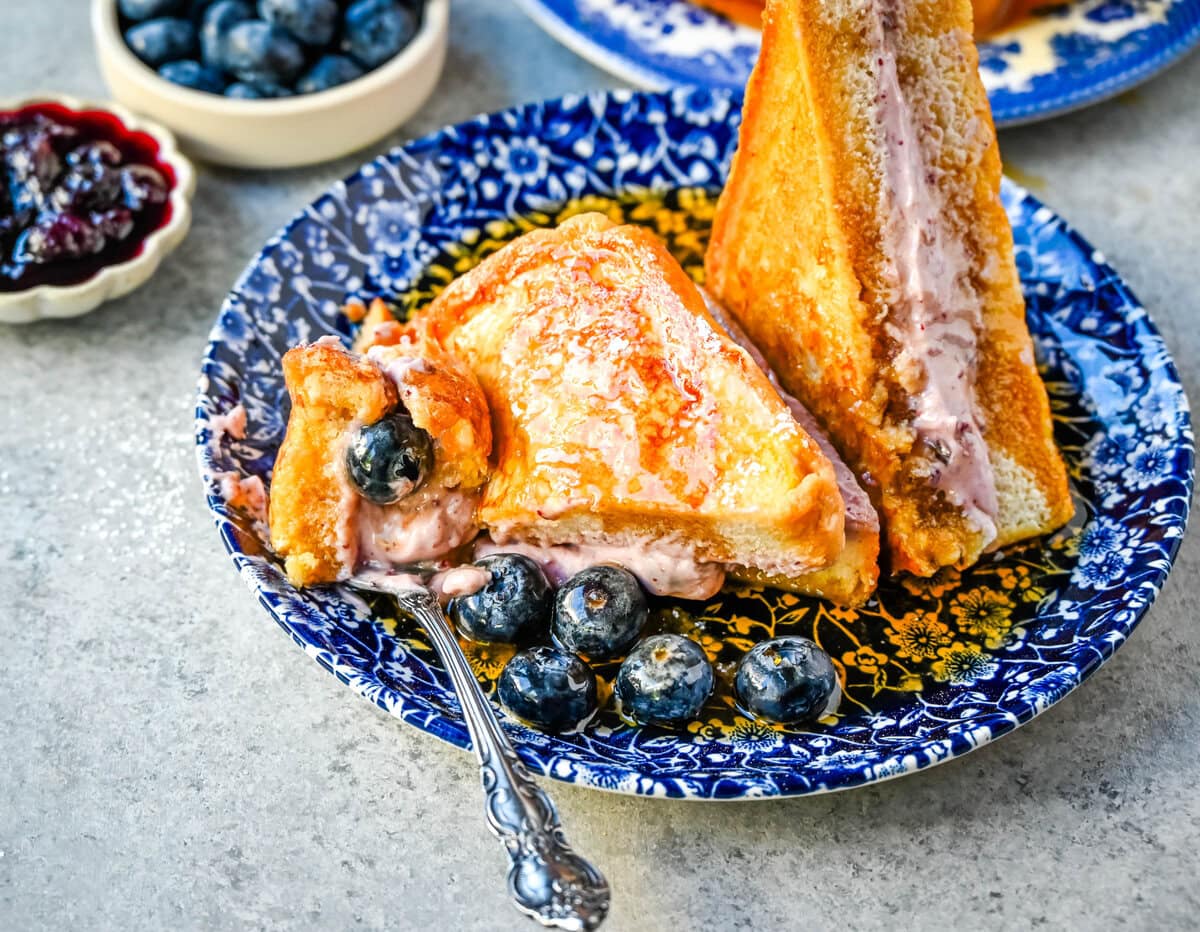 Blueberry Cheesecake Stuffed French Toast. This Blueberry Cream Cheese Stuffed French Toast Recipe is made with soft, thick bread stuffed with a homemade blueberry cream cheese and dipped in a vanilla custard batter and cooked until golden. 