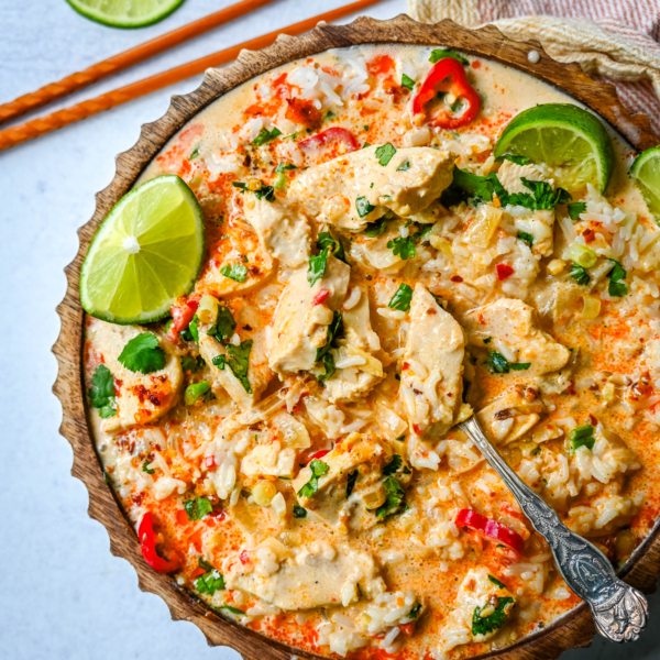 This tender Poached Coconut Milk Chicken with aromatics, creamy coconut milk, red Thai curry paste, and spices all atop rice is made in less than 30 minutes and is perfect for a weeknight dinner.