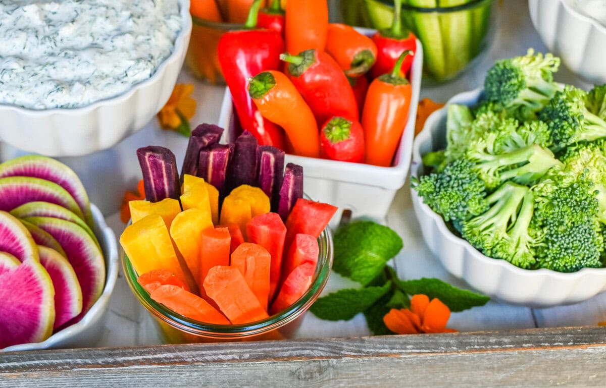 Rainbow heirloom carrots and mini sweet peppers. How to create a beautiful crudite platter also known as a vegetable platter, veggie tray or veggies and dips. Ideas on what vegetables to use and what dips to pair with vegetables.