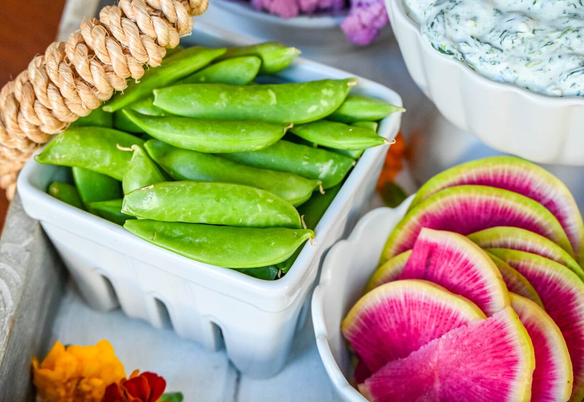 Snap peas on vegetable board also crudite platter