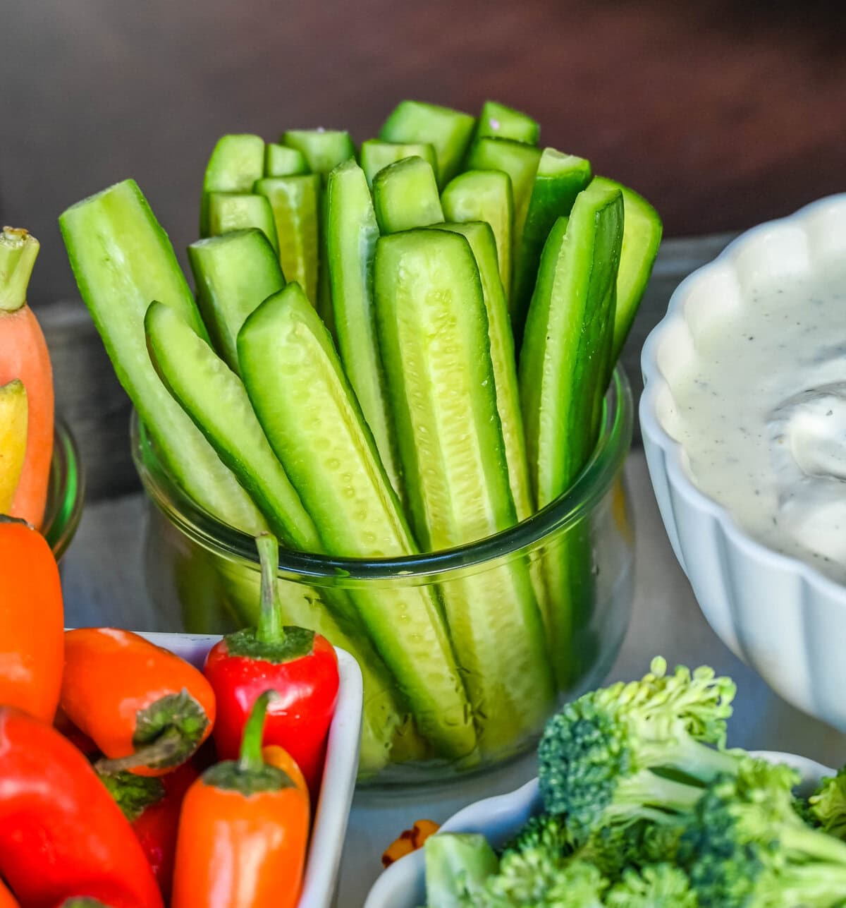 Hot House or English cucumbers in a jar on a crudite platter or veggie tray.