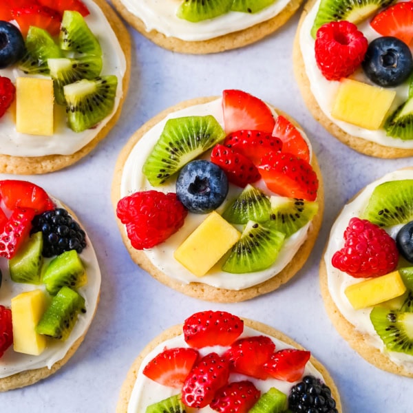 These Fruit Pizza Cookies are made with soft, chewy, buttery sugar cookies topped with a sweet cream cheese frosting and fresh fruit. These Sugar Cookie Fruit Pizzas are always a huge hit!